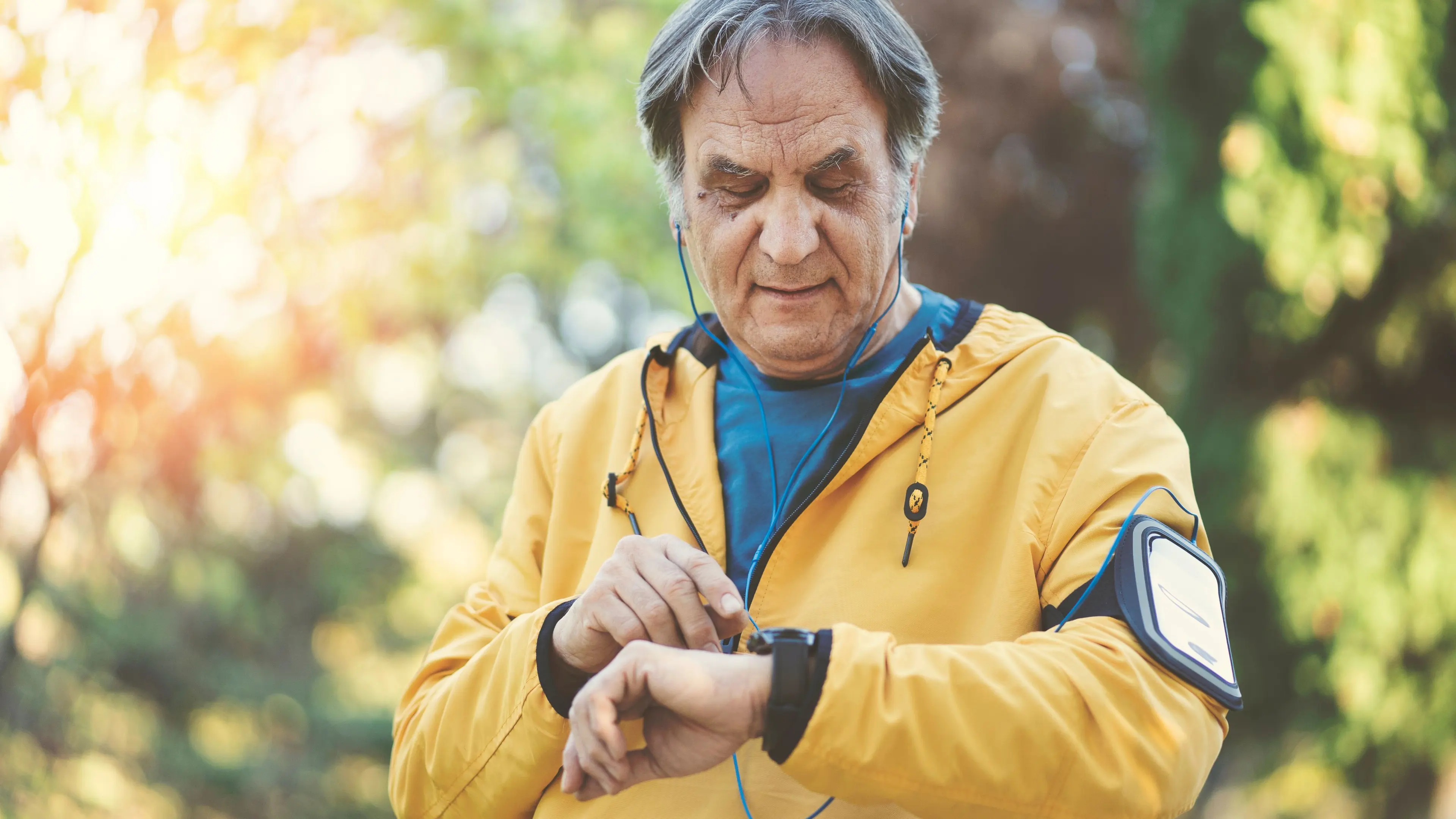 an older man checks his activity tracking watch